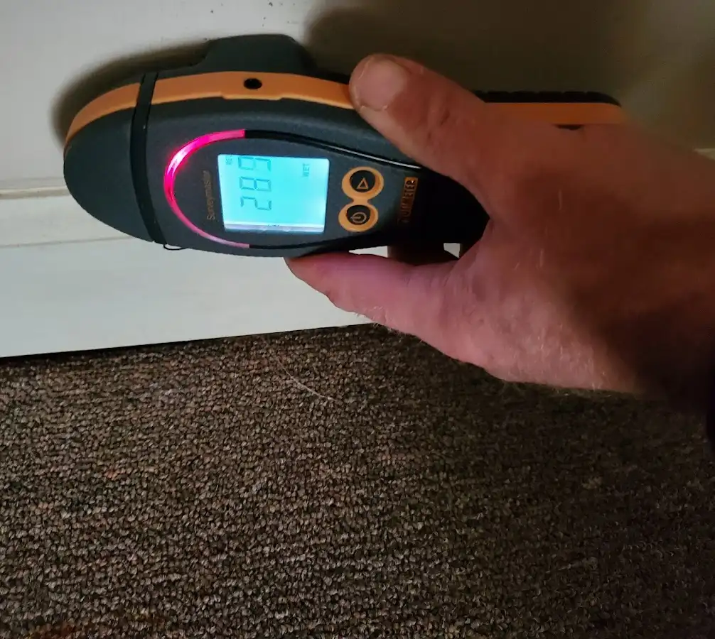 Moisture detection at baseboard during Storm Damage Restoration in The Acreage